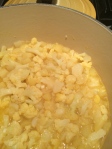 simmering the potatoes and cauliflower